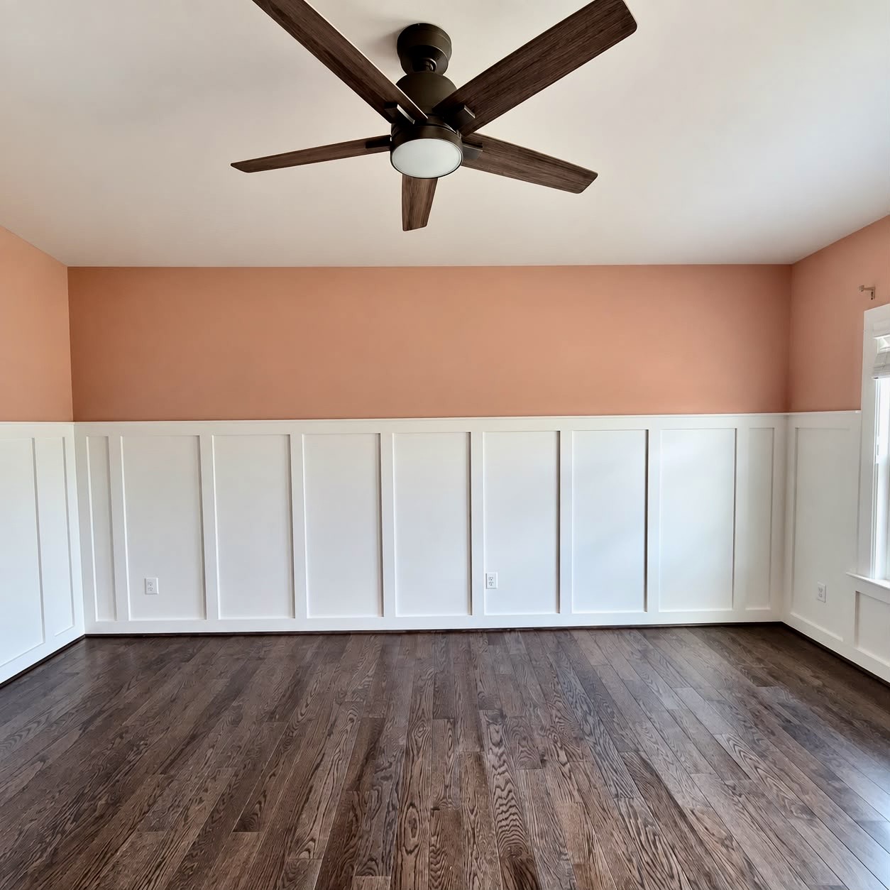Finished flooring, painted walls and custom white trim in a residential room
